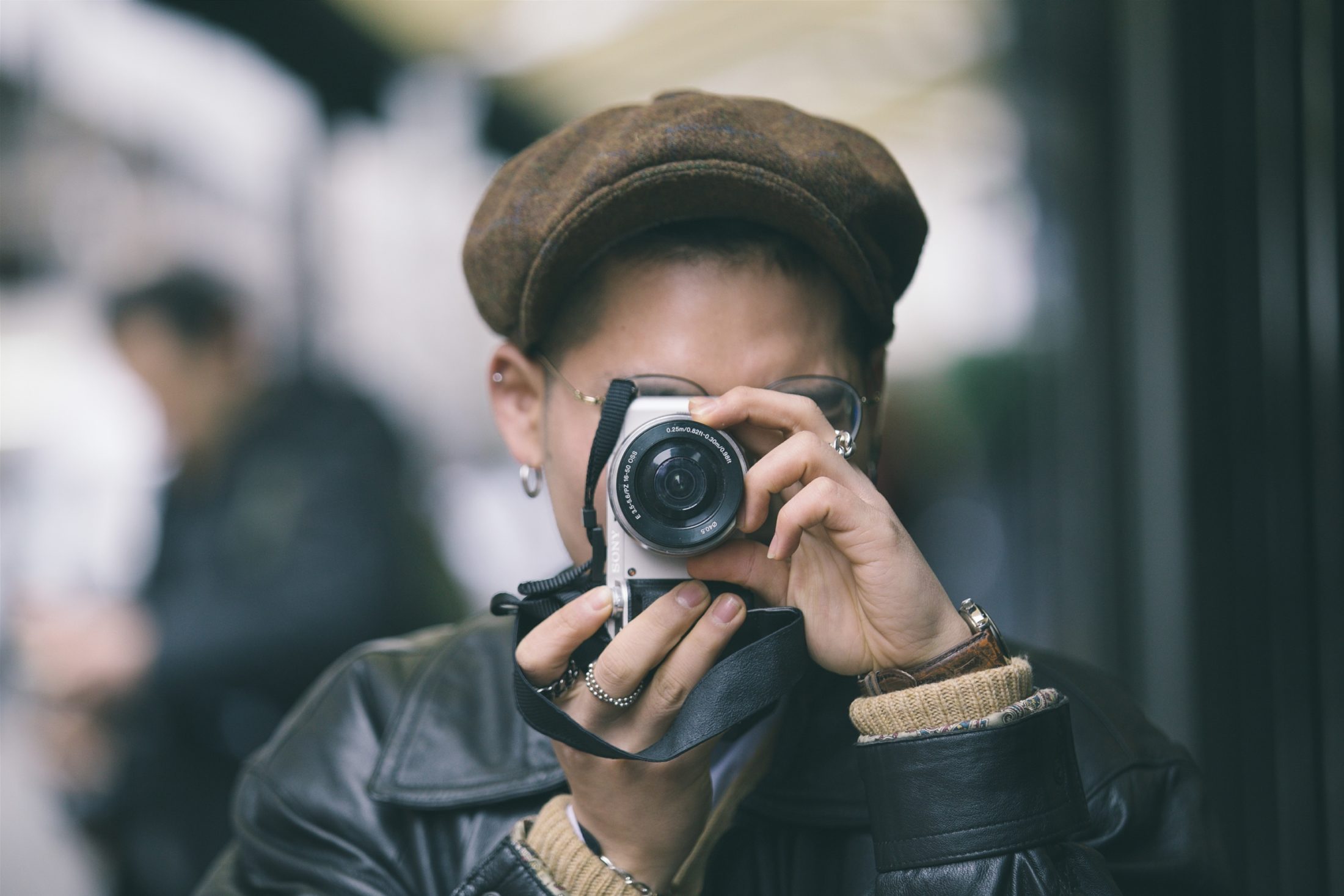 focus photography of person holding camera